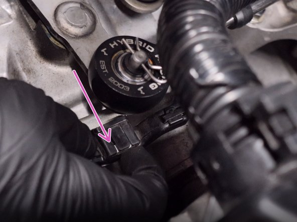 Remove the wire harness from the bracket on the front of the transmission.