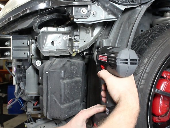 With the bumper off, remove the lower section of the air intake tube.