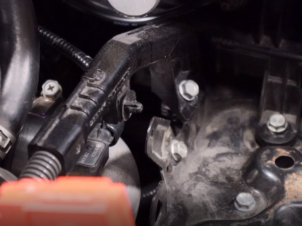 Unclip the wiring harness from the metal battery bracket.