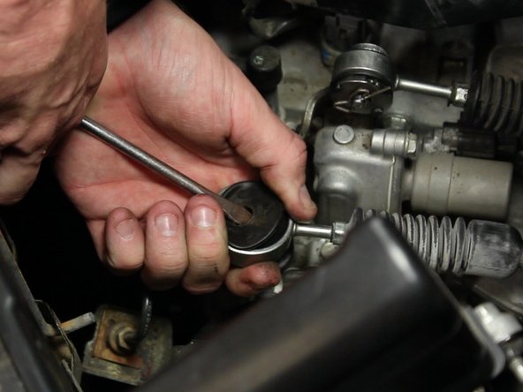 Pry the remaining rubber bushing out of the cable end.