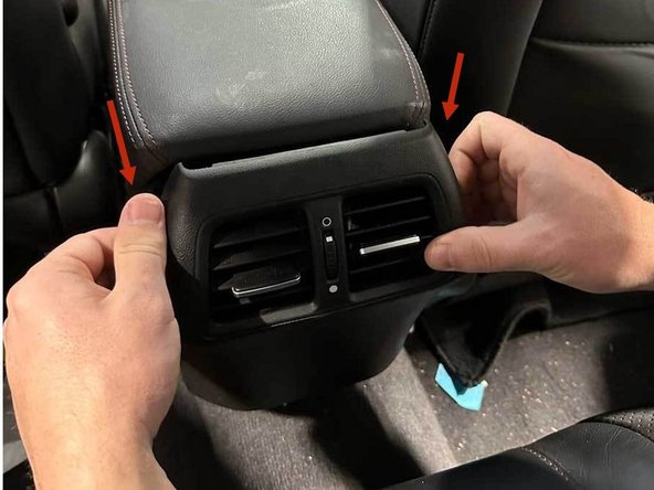 From the back seat, pull the AC vent bezel until it releases.