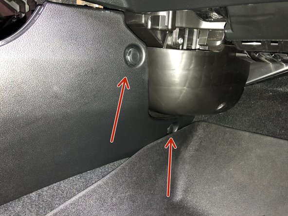 Using a plastic trim tool, remove the two push clips on the RH side and one on the LH side of the console. Set them to the side.