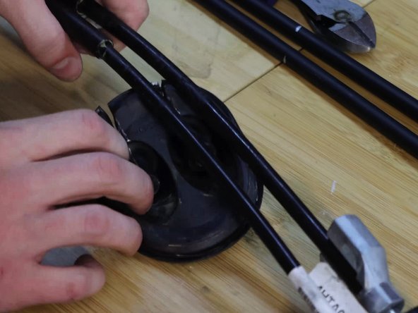 Slice the grommet down the center of each cable and peel it back.