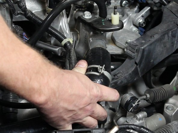 Install the new upper radiator hose and slide the clamps back into place.