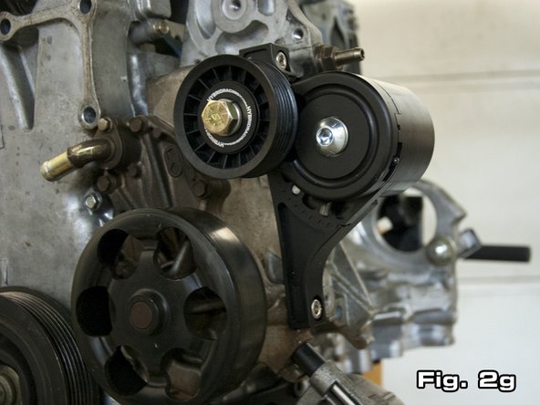 The autotensioner is supplied in its lowest position. Figure 2f shows how no open grooves are visible at the lower portion of the autotensioner. Figure 2g shows the autotensioner adjusted to its highest setting, where 4 grooves are showing. In the case of a k24, typically 2-3 grooves will need to show if the supplied belt is used.