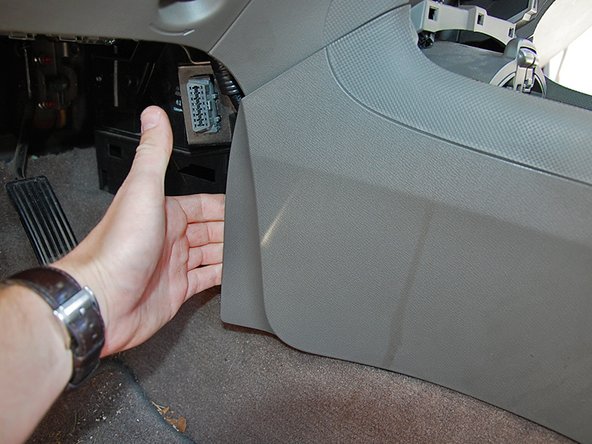 Reach behind the front lower side on each side of the center console and pull gently to unsnap it