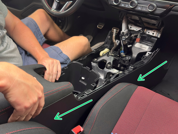 Slide the console backward and remove it from the car. It should be completely loose and free of all wires and bolts.