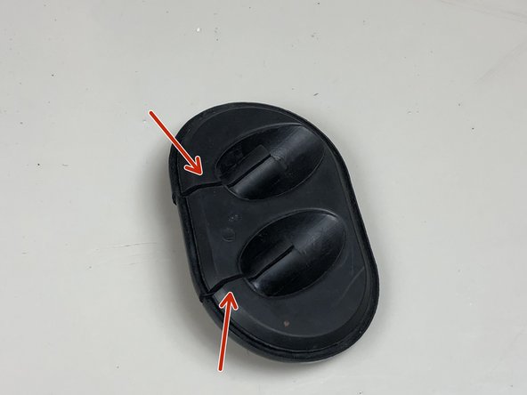 Two cuts will allow the shifter cable grommet to slide off.