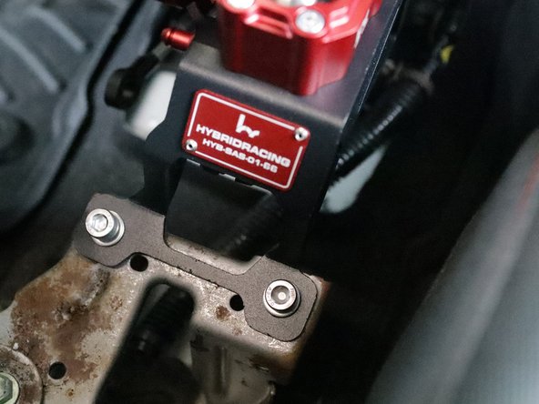 Use the supplied mounting hardware to bolt the Hybrid Racing shifter to the chassis.