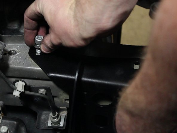 Using the supplied bolts, thread in and tighten the battery tray in place.