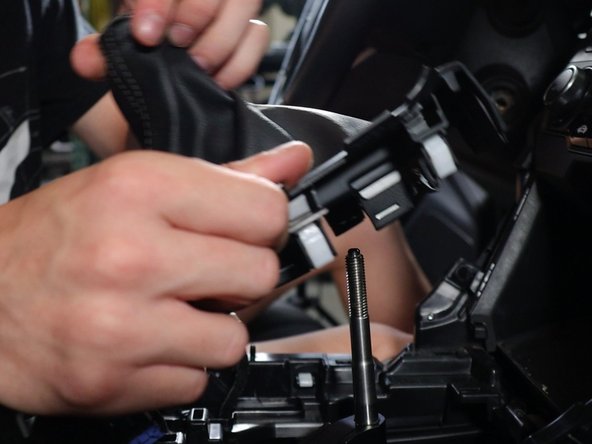Lift the shift boot cover upwards and unplug all of the electrical connectors.