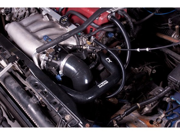 Install the high flow air filter and tighten all connections. Make sure the edge of the air filter does not contact the lower frame pinch weld.