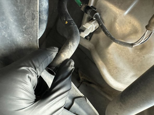 Unclip A/C Condenser drain from stand-off mount