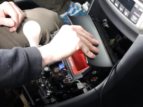 Remove the coin pocket and unplug the 12v socket.