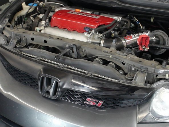 Once the upper cover is out of the way, remove the bolts that hold the grill brackets in place.