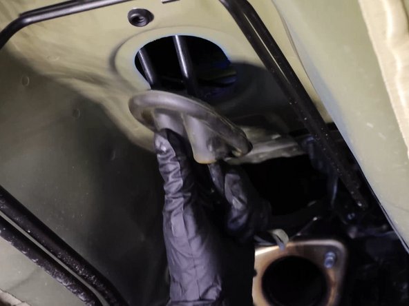 Pull the rubber seal down and remove the shifter cables from the cabin.