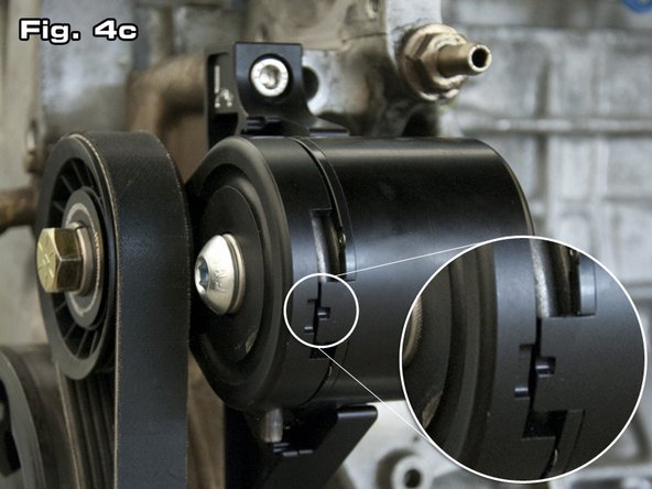 Once the belt has been installed, check the tension indicator markings on the side of the autotensioner (as highlighted in Figure 4c). The small marking should fall inside of the larger marking if the belt is properly tensioned.