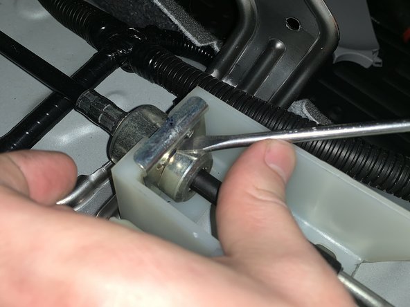 Use a flat head screw driver and remove the shifter cable C clip from the RH side cable.