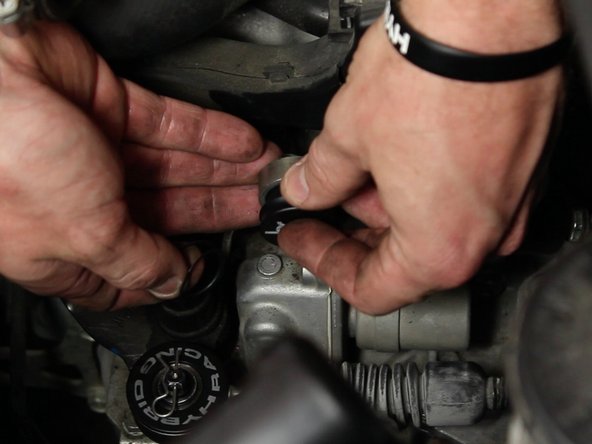 Install the Hybrid Racing bushing, logo facing outward.