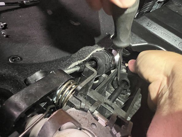 Then rotate the shifter cable and slide it upward, removing it from the shifter base.