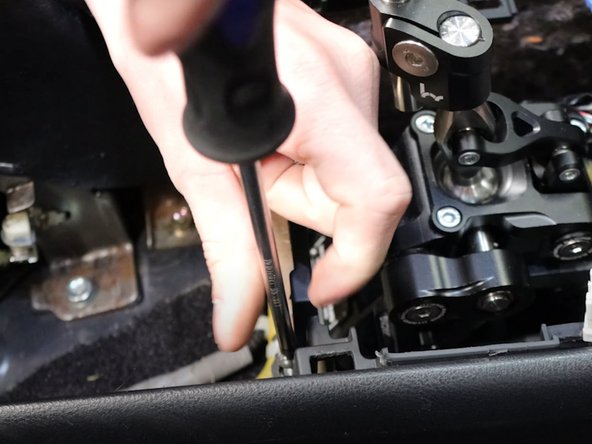 Remove all of the Phillips screws holding the console and coin pocket in place.