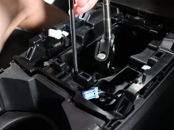 Remove the center console screw.