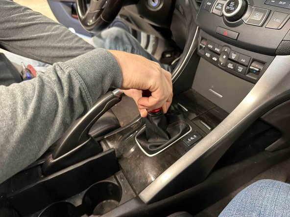 The OEM shifter may have lock nut holding the stock knob on