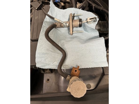 Using pliers, loosen clamp on reservoir hose at the CMC. Then immediately move hose to new CMC.