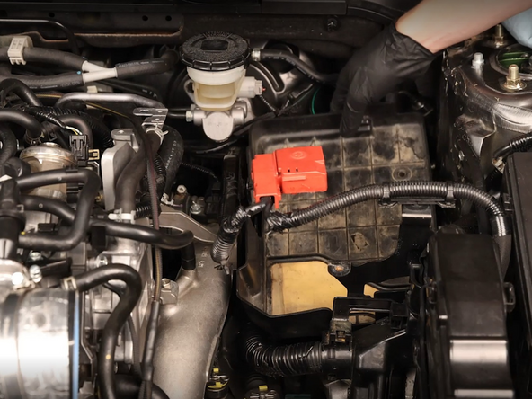 Remove the plastic battery tray and unbolt the battery bracket. Be sure to remove the bolts on the tray and frame.