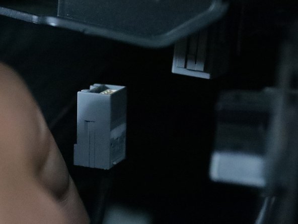 Unplug the gray connector near the front of the console and slide the entire console backward.