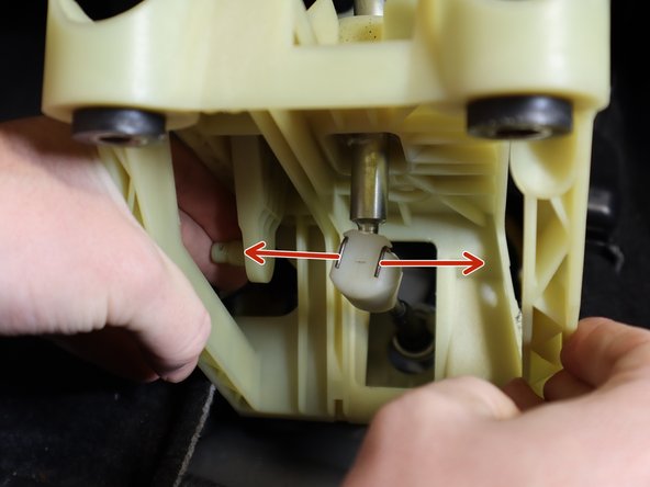 Pick the shifter assembly up and remove the shifter cable.