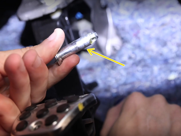 Remove the pin to free the clevis from the pedal.