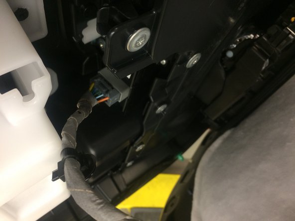 Once the three screws in the previous step are removed, the door panel is only held by clips.