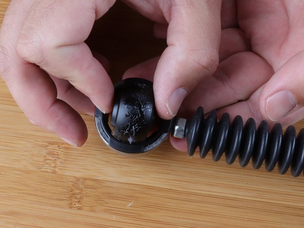 Aling the sides of the ring with the bushing and slide it in. Once inserted, rotate it 90* to lock it in place.