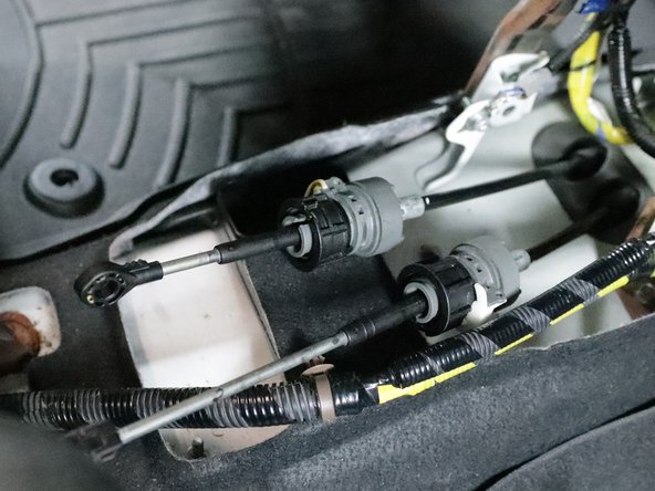 Use a 12mm socket and remove all four bolts that hold the shifter in place. Remove the shifter from the car.