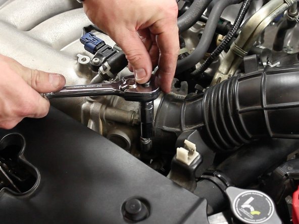 Loosen the intake tube clamp from the throttle body.