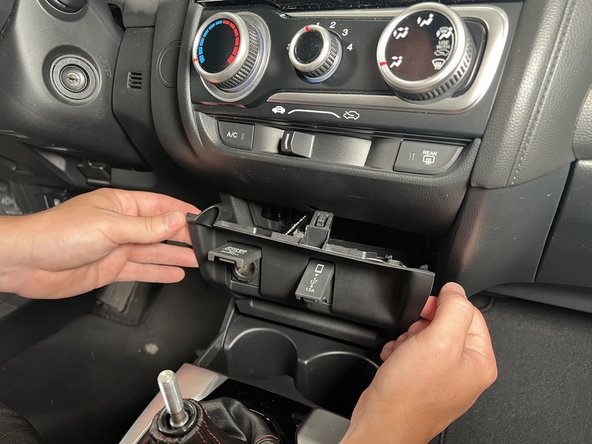 Pull it forward to release the clips.