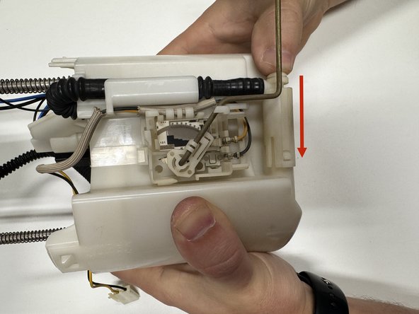 Make sure it routes behind the level sending unit. Clip the hose back into its original position.