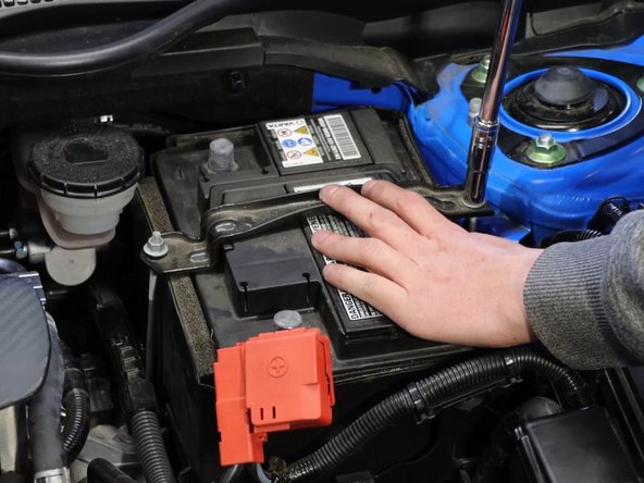 Remove the battery tie-down bracket.