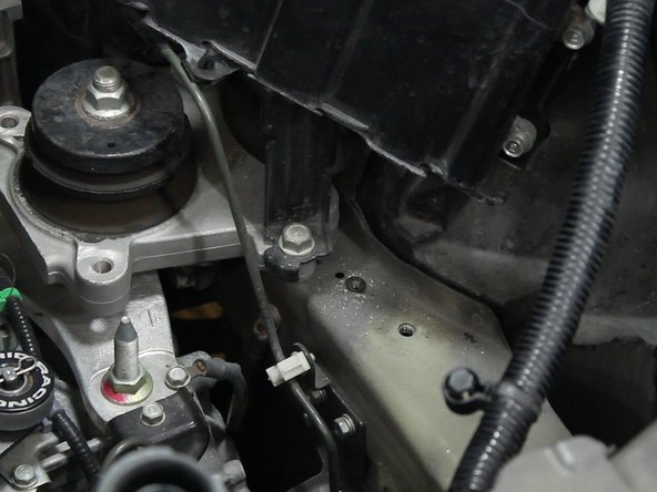 Remove the battery ground terminal from the upper frame rail.