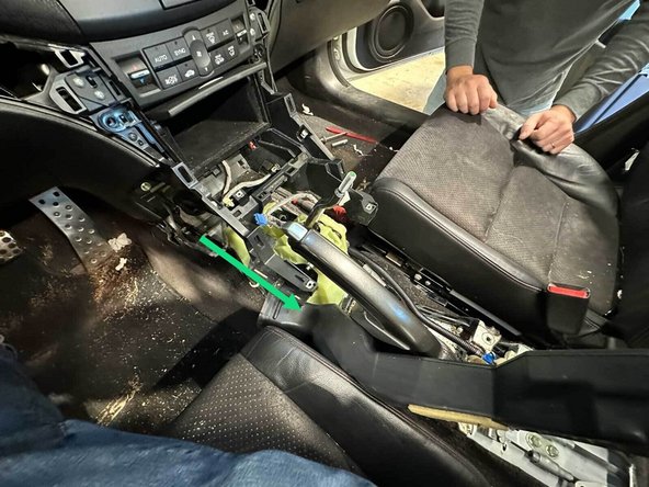 Slide the driver's side AC vent back and out of the center of the car.