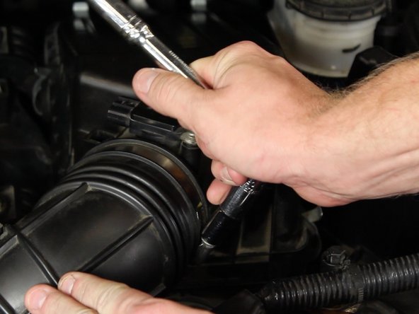 With a 10mm socket, loosen the factory hose clamp on the factory air tube.