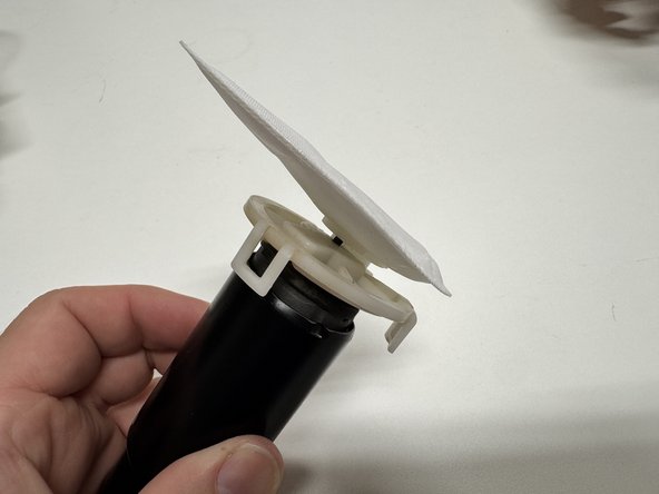 Reinstall the rubber pump isolator and plastic retainer.