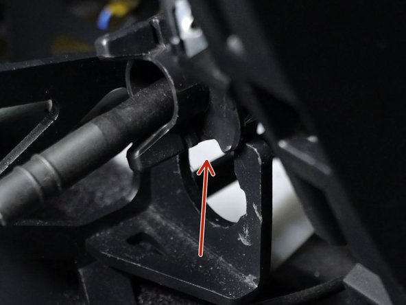 Rotate the left side shifter cable counter-clockwise and slide it upwards, removing it from the shifter base.