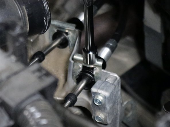 Then install the shifter cable spring clips that you removed earlier.