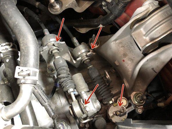 Remove the shifter cable pins and slide the cables off the transmission.