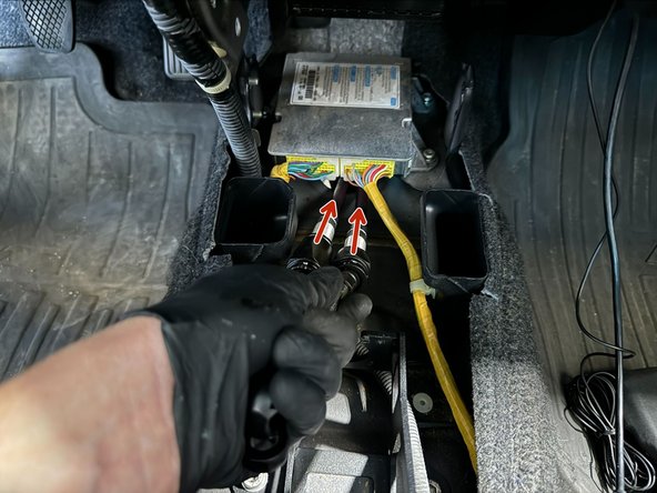 Front underneath the vehicle, pull/push cables out of the vehicle.