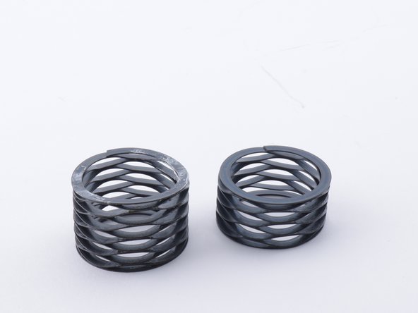 The SH Spring is considerably taller than the H Spring. This is an easy way to tell them apart at a glance. You can also compress them in your hand to feel the difference.