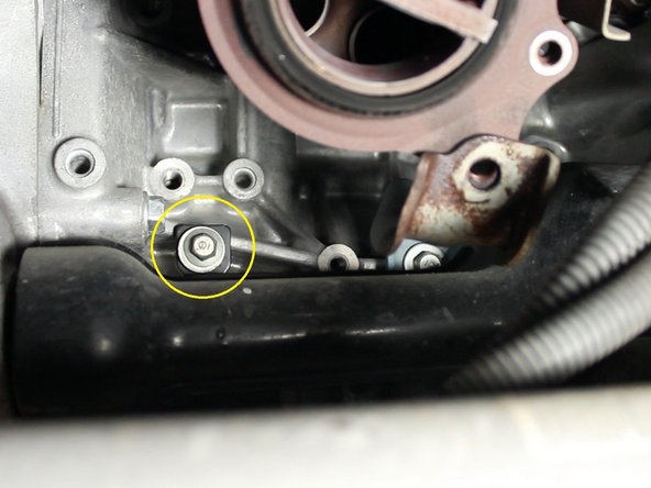 Remove the three 12mm bolts that attach the half shaft cover from the engine block.
