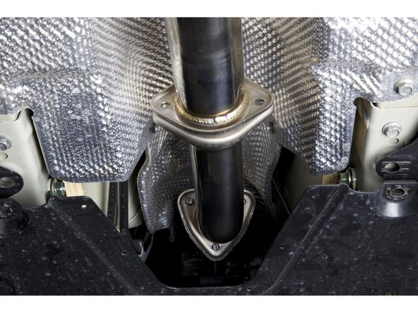 With both gaskets installed on the front pipe adapter, install it on the car. Be sure to keep the bolts loose for the time being.